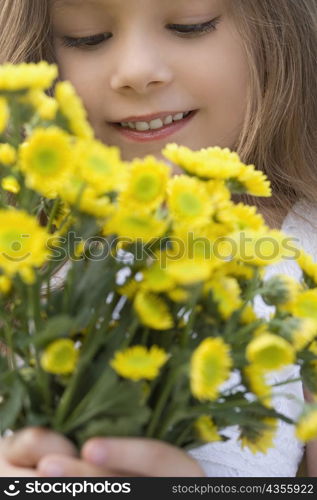 Close-up of a girl holding a bunch of flowers