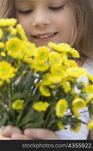 Close-up of a girl holding a bunch of flowers