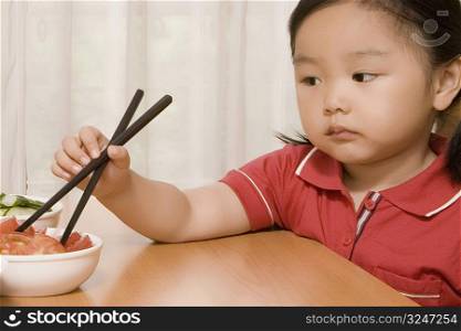 Close-up of a girl holding a chopsticks