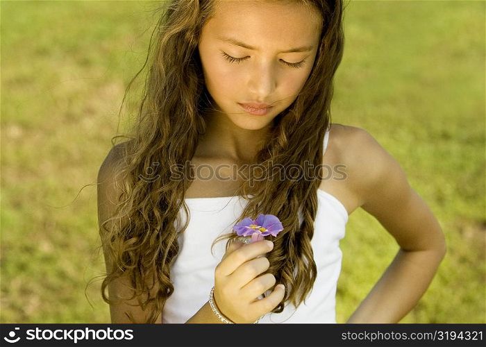 Close-up of a girl holding a flower