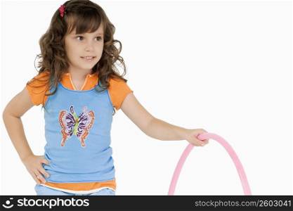 Close-up of a girl holding a hula hoop and smiling