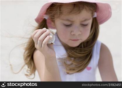Close-up of a girl holding a seashell