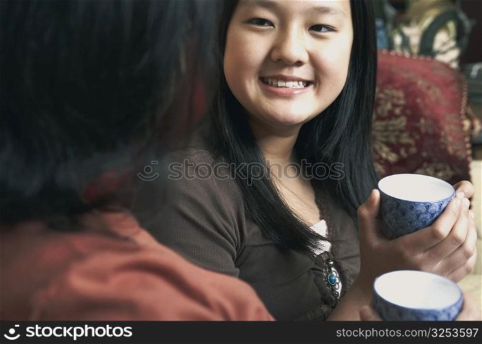 Close-up of a girl holding a tea cup