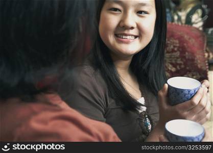 Close-up of a girl holding a tea cup