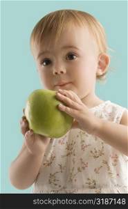 Close-up of a girl holding an apple