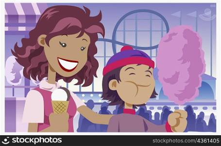Close-up of a girl holding an ice-cream cone with her brother holding cotton candy