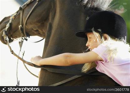Close-up of a girl horseback riding