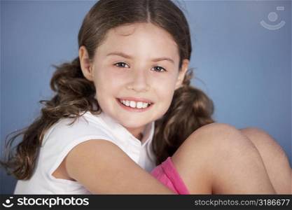 Close-up of a girl hugging her knees