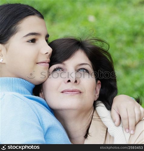 Close-up of a girl hugging her mother
