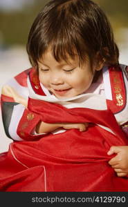 Close-up of a girl in traditional clothing smiling