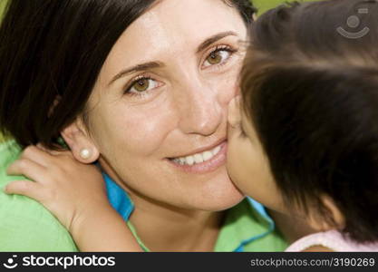 Close-up of a girl kissing her mother