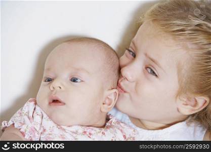 Close-up of a girl kissing her sister