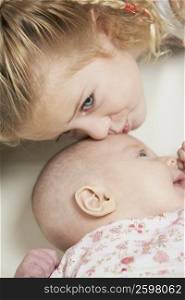 Close-up of a girl kissing her sister
