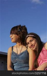 Close-up of a girl leaning on a teenage girl&acute;s shoulder