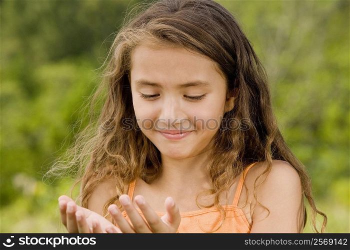 Close-up of a girl looking at her hands
