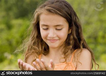 Close-up of a girl looking at her hands
