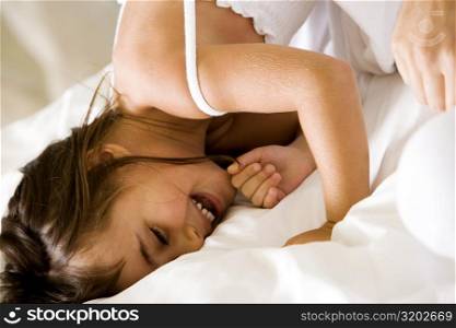 Close-up of a girl lying on the bed smiling