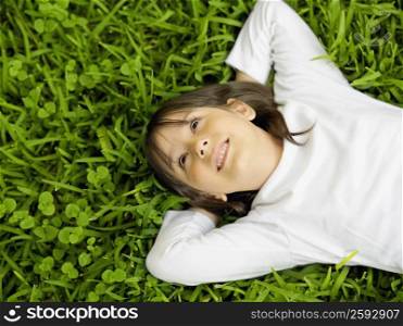 Close-up of a girl lying on the grass