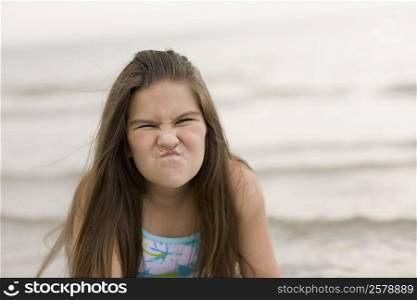 Close-up of a girl making a face on the beach
