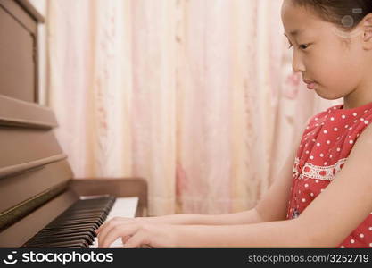 Close-up of a girl playing a piano