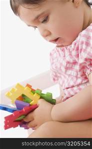 Close-up of a girl playing with toys