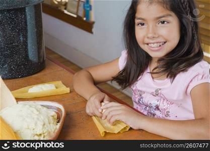 Close-up of a girl preparing bread