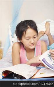 Close-up of a girl reading books