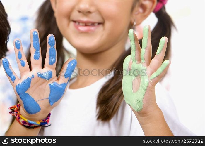 Close-up of a girl showing her painted palms