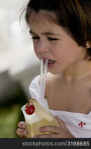 Close-up of a girl sipping drink from a glass