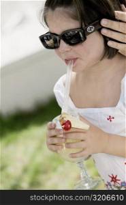 Close-up of a girl sipping drink from a glass