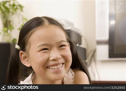 Close-up of a girl smiling and looking away