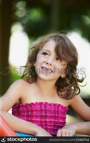 Close-up of a girl smiling and looking up