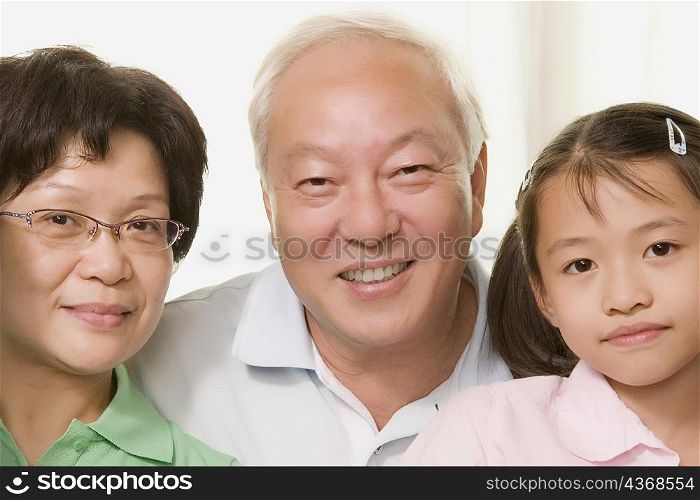 Close-up of a girl smiling with her grandparents