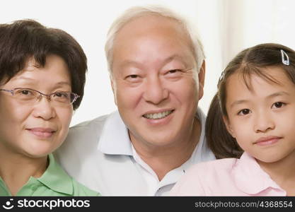 Close-up of a girl smiling with her grandparents