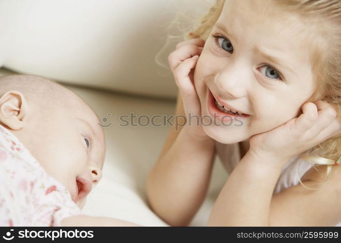 Close-up of a girl smiling with her sister