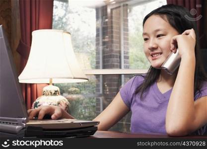Close-up of a girl talking on a cordless telephone