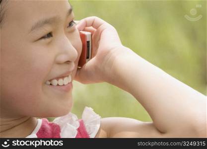 Close-up of a girl talking on a mobile phone and smiling