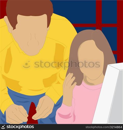 Close-up of a girl using a computer with her father standing behind her