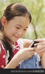 Close-up of a girl using a mobile phone