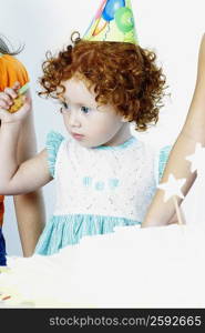 Close-up of a girl wearing a birthday hat