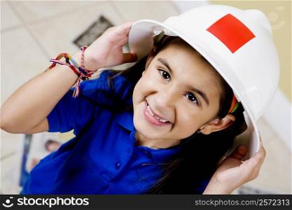 Close-up of a girl wearing a hardhat and smiling