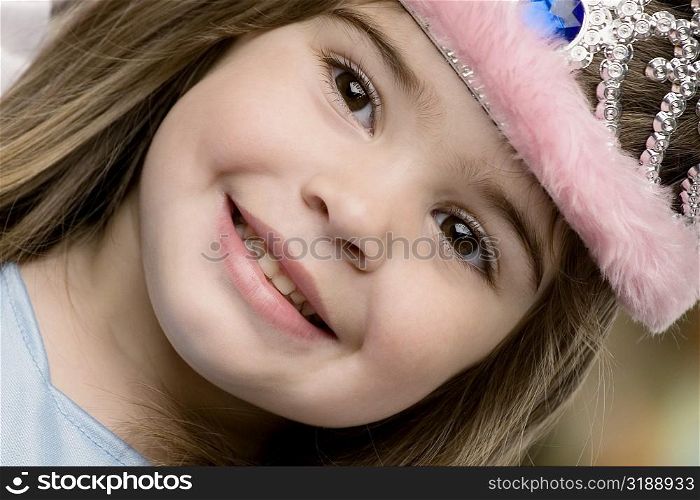 Close-up of a girl wearing a tiara and smiling