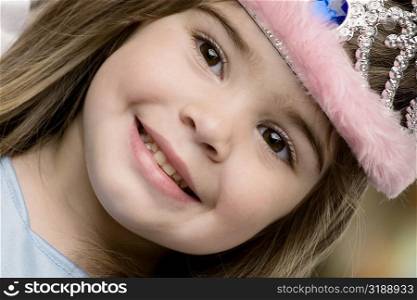 Close-up of a girl wearing a tiara and smiling