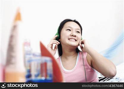 Close-up of a girl wearing headphones listening to music