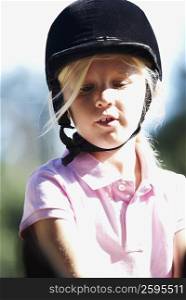 Close-up of a girl with a riding hat on her head