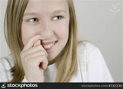 Close-up of a girl with her finger in her nose