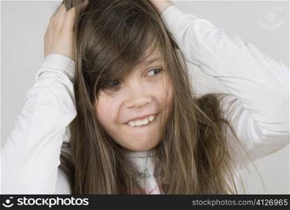Close-up of a girl with her hands in her hair