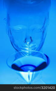 Close-up of a glass of martini in front of a glass mannequin