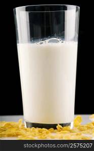 Close-up of a glass of milk with corn flakes