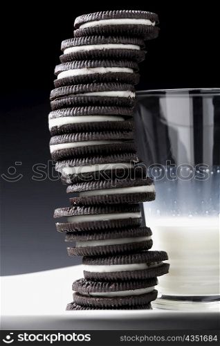 Close-up of a glass of milk with stack of cookies